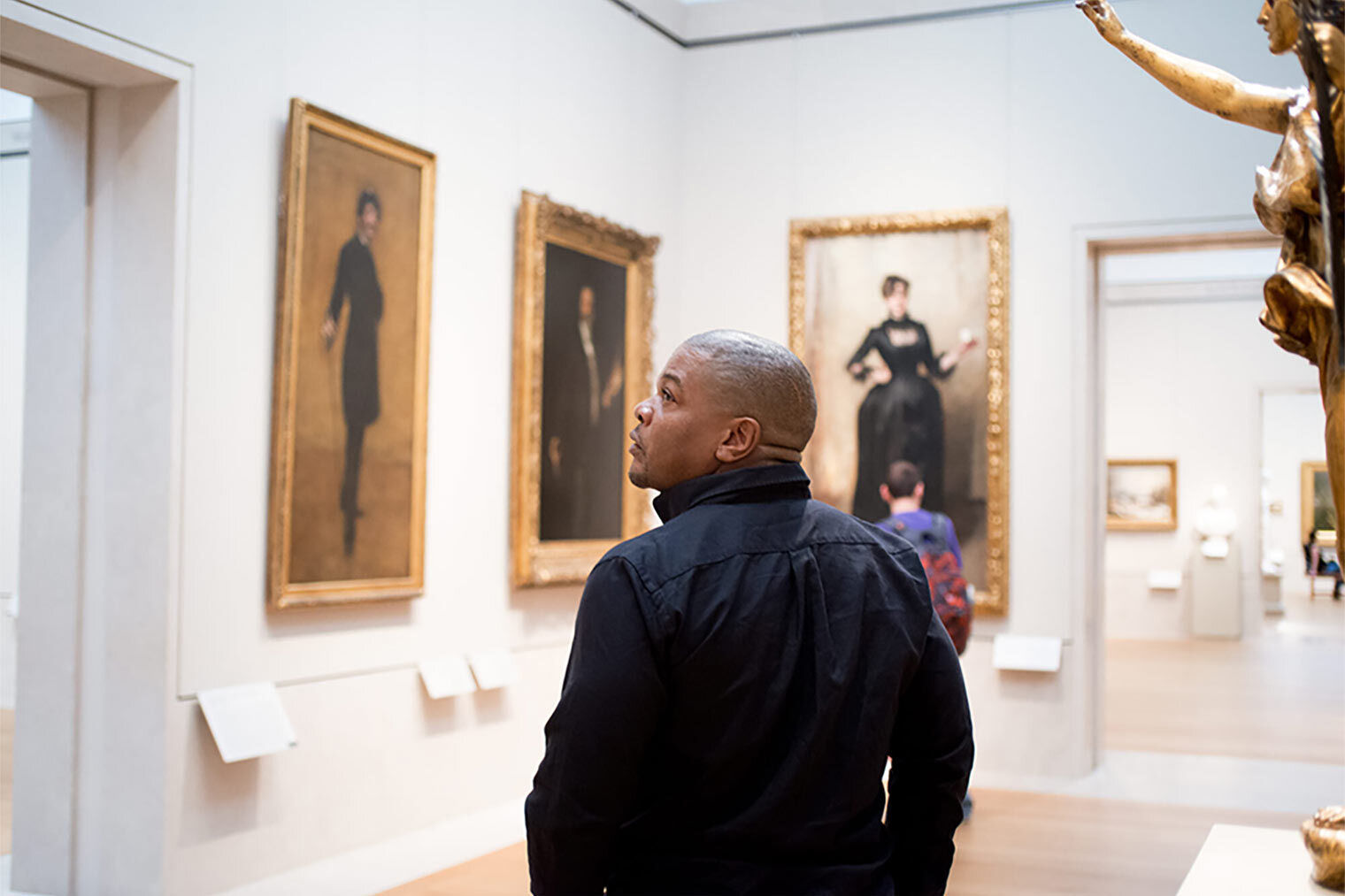 The artist Kehinde Wiley walks through a gallery of portraits by Sargent