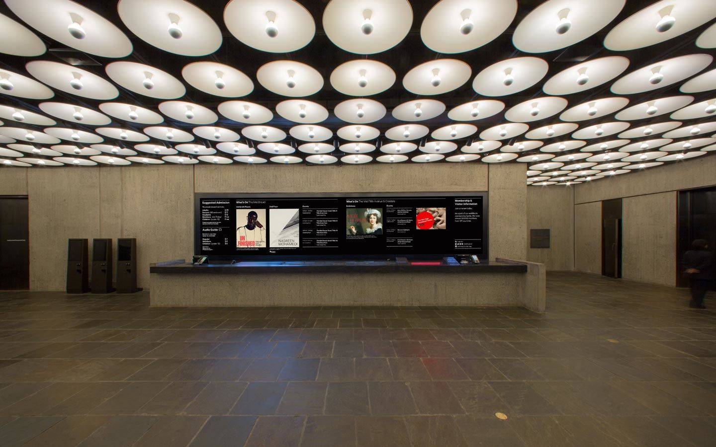 View of the media wall behind the information desk in The Met Breuer lobby