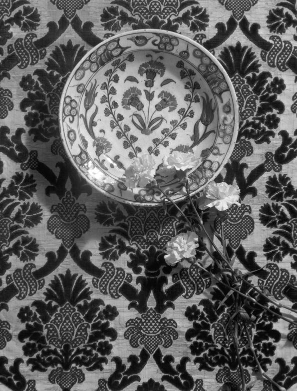 Iznik bowl displayed with live carnations and an Italian velvet, 1933