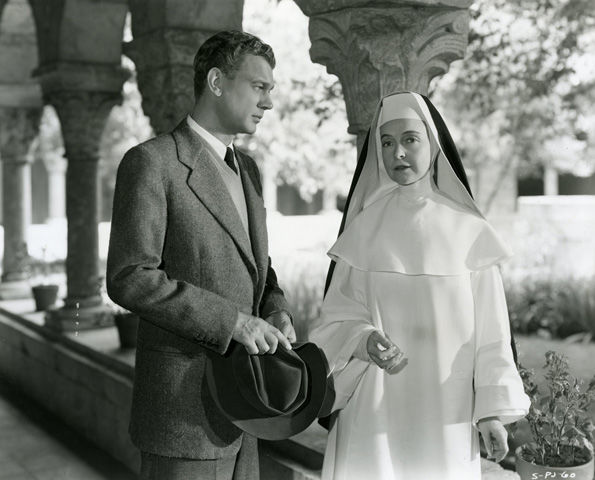 Joseph Cotton and Lillian Gish pose in the Cloister from Saint-Michel-de-Cuxa (25.120.398–.954) during the filming of Portrait of Jennie in 1947.