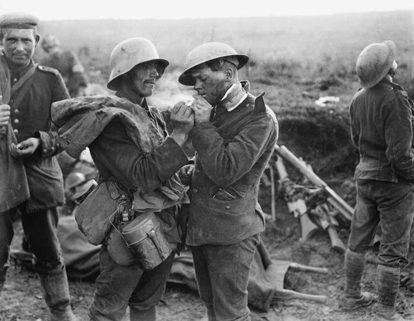 German soldier giving wounded British soldier a light