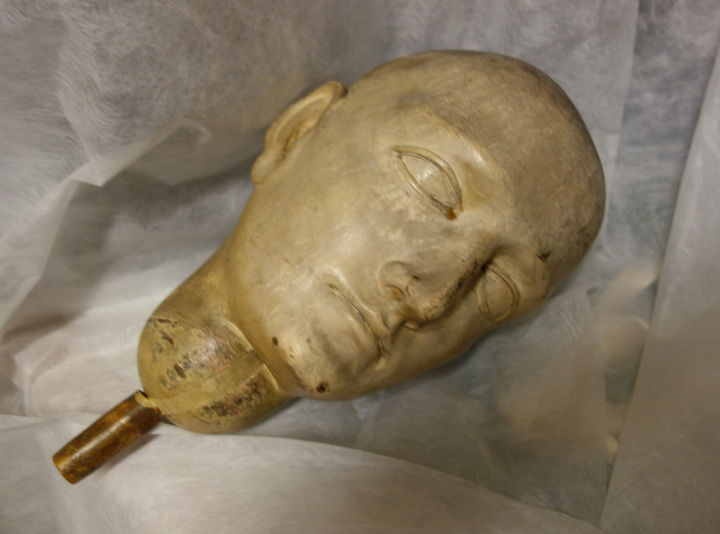 A detail view of the mannequin's head after removal from the object's body