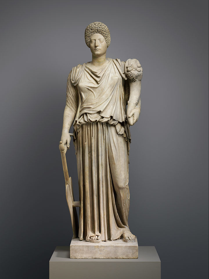 A marble statue of Tyche-Fortuna restored with the portrait head of a woman