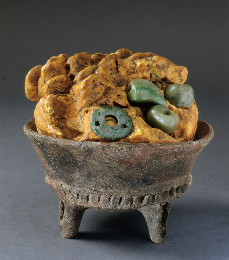 Photo of a Maya tripod bowl containing copal and jadeite beads