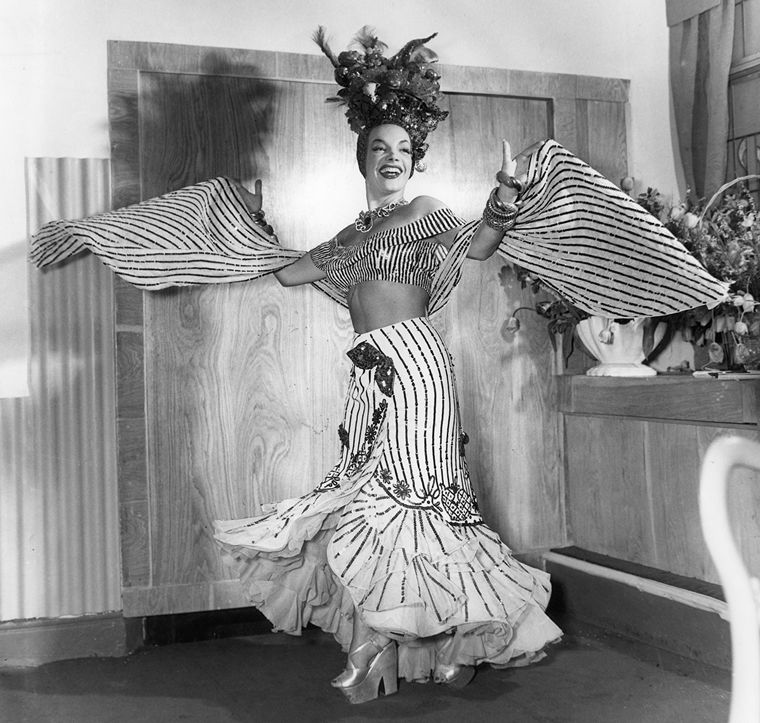 A black-and-white photo of Carmen Miranda in full costume.