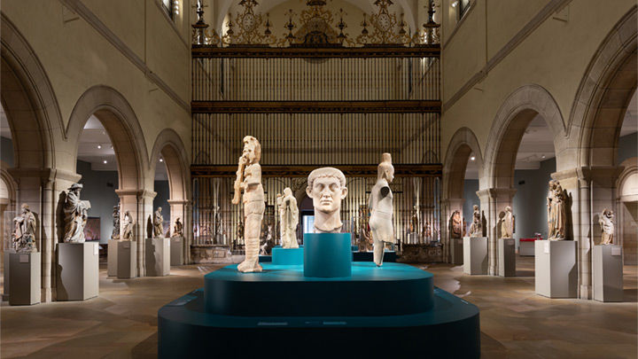 A view of the Medieval Sculpture Hall, with a blue plinth supporting sculptures from many different civilizations