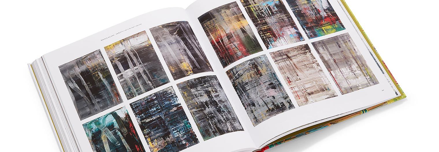 An open book with twelve abstract paintings