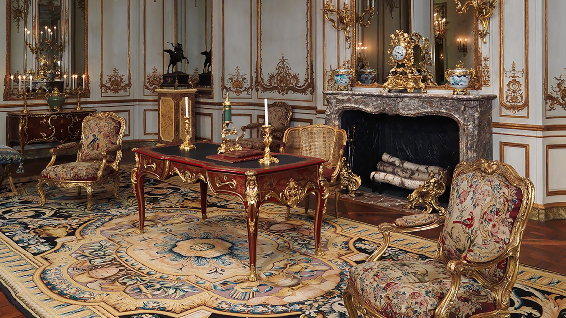 An ornate room with gilded furniture and decorative objects