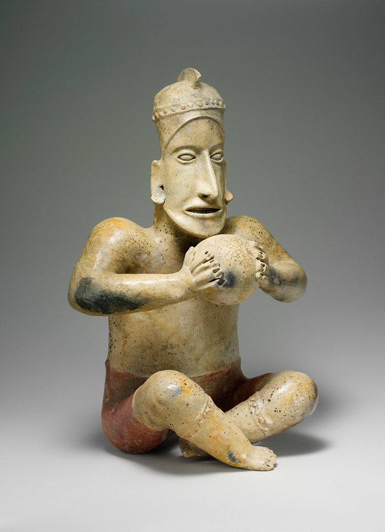 Figure of a man holding a ball in his hands