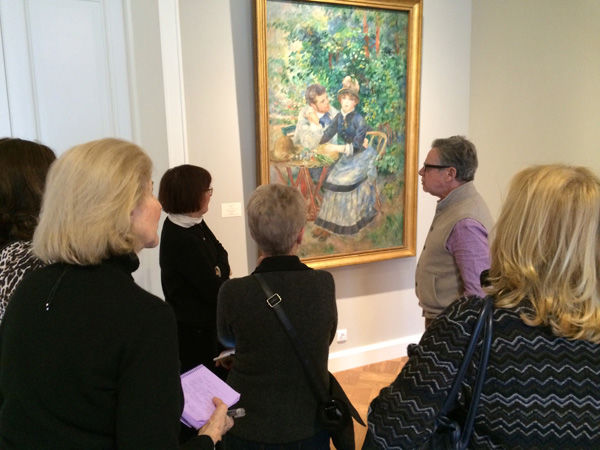 The group admires a painting at the Hermitage Museum  