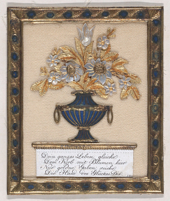 Collaged greeting card of a blue vase holding gold and mother-of-pearl flowers in a gold frame.