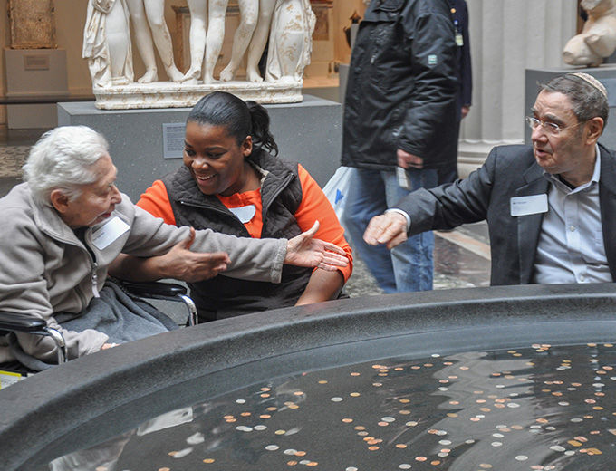 A group of visitors talk in the Greek and Roman Sculpture Court