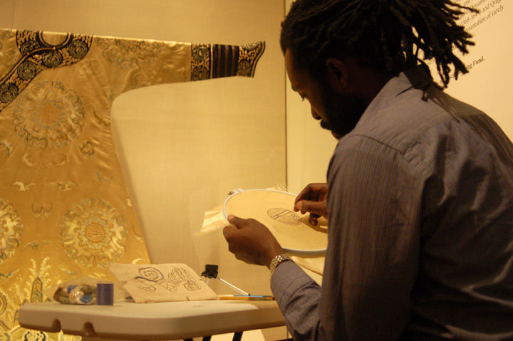 An artist recreating an artwork in the galleries