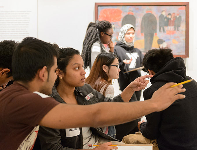 Woman lecturing in American paintings gallery using an iPad to show comparative images