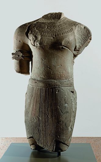 Statue of standing man wearing jewelry