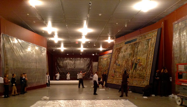 View of the gallery with the tapestries being hung