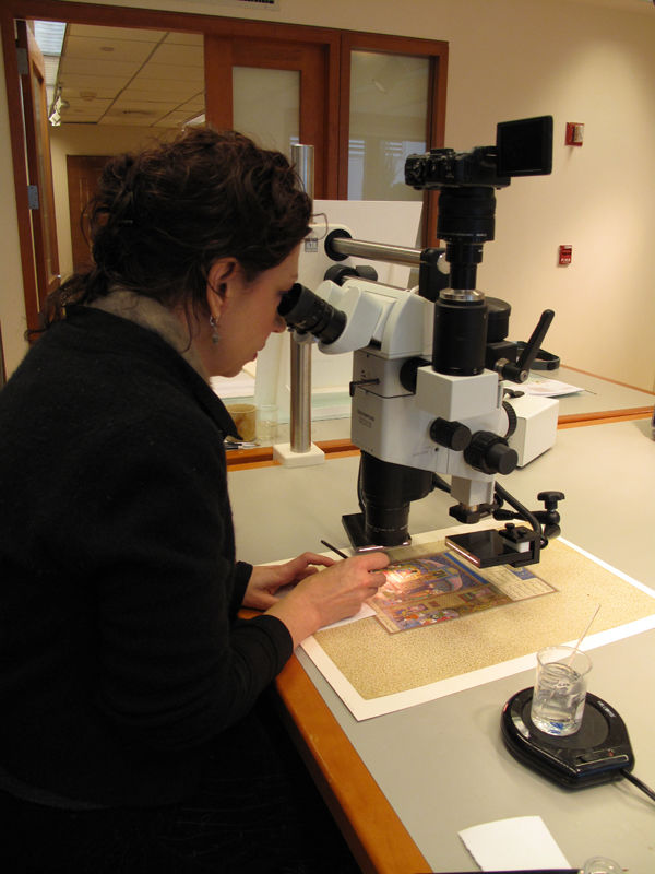 Figure 4. Conservator Yana van Dyke at a microscope stabilizing paint layers