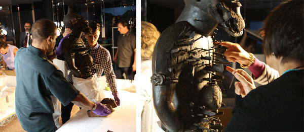 Charles Dixon, Departmental Technician, left, and David Rhoads, AAOA Collection Specialist, right, carefully place the Mangaaka upright