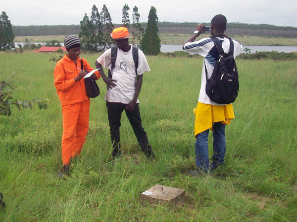 Three people standing in a field