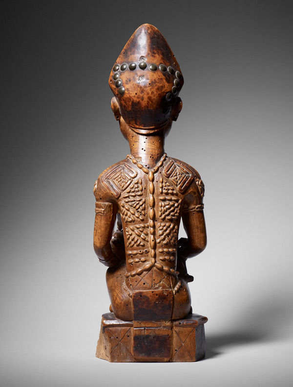 Seated Female Nursing Child (back)