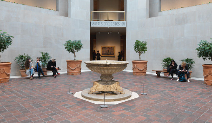 View of the Robert Lehman Wing's atrium and the entrance to "Seurat's Circus Sideshow"