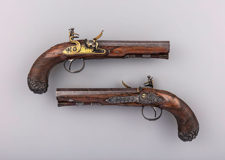 Two gold decorated pistols