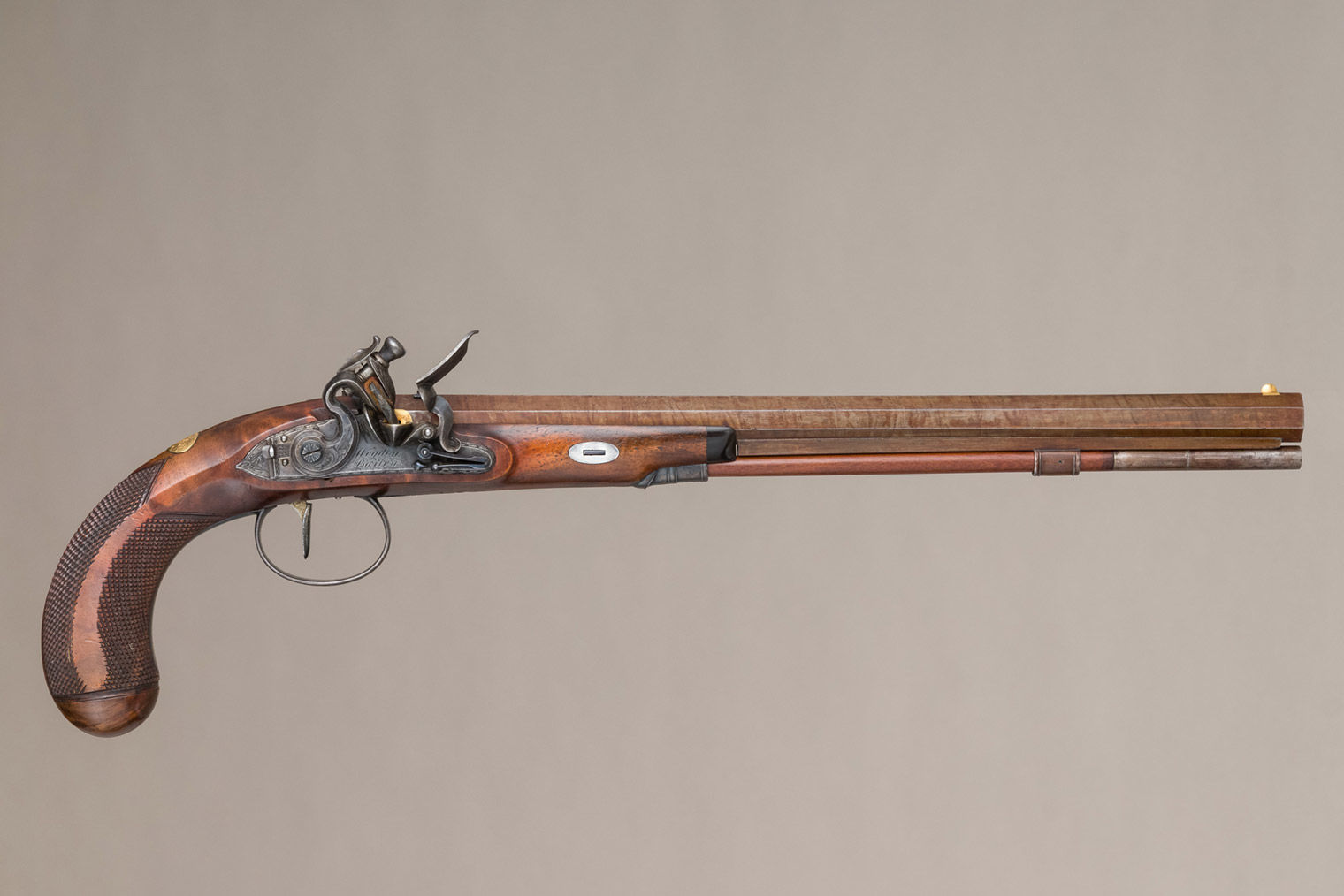 One flintlock pistol displayed in a custom case