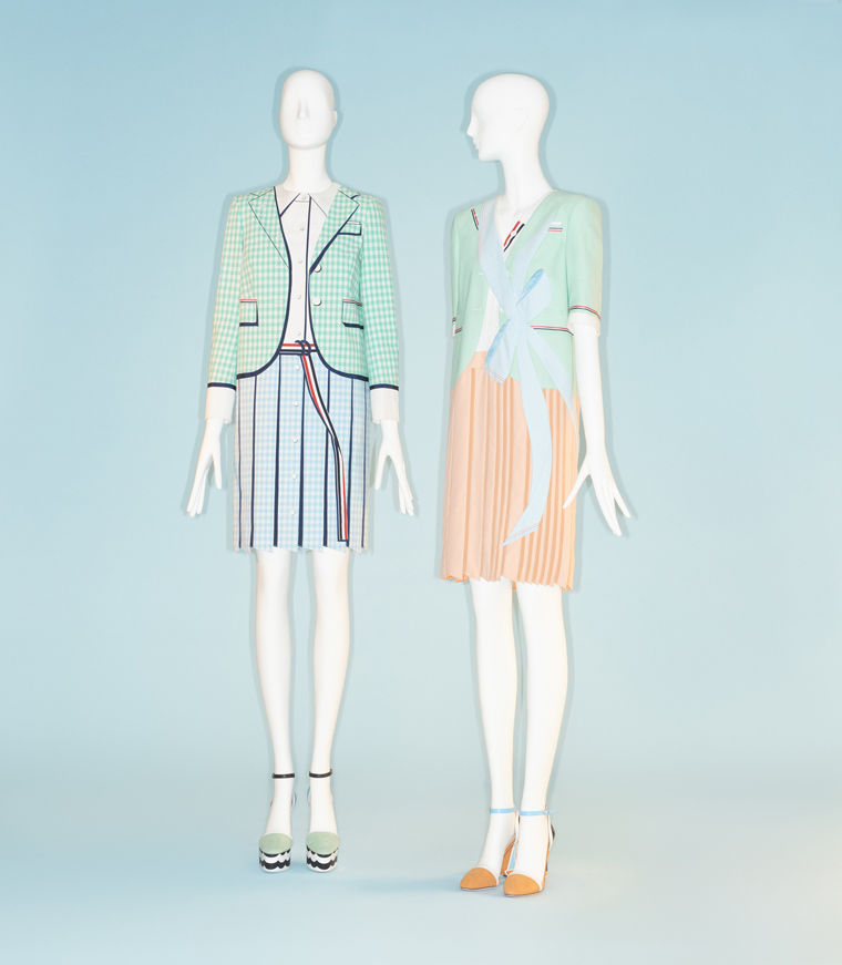 Two women's ensembles of blazers and pleated skirts in bright mint colors