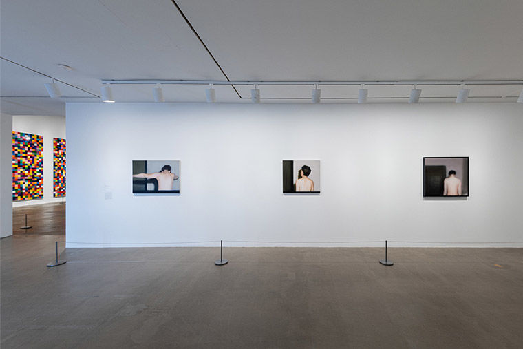 Installation view of three paintings of his wife, Isa Genzken, from behind from Gerhard Richter: Painting After All at The Met Breuer