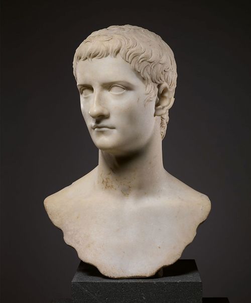 White sculpture of a male head with short curling hair