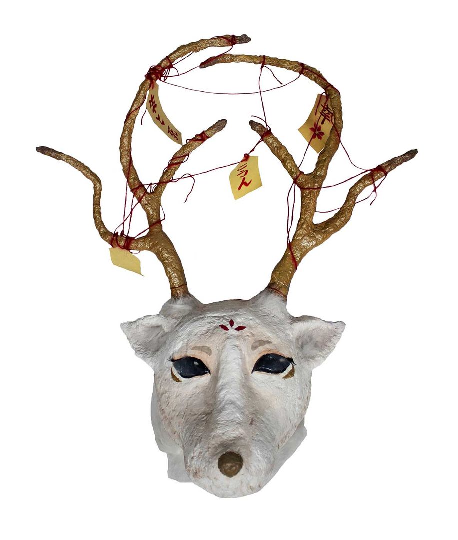 papier mâché sculpture of a horned white animal.