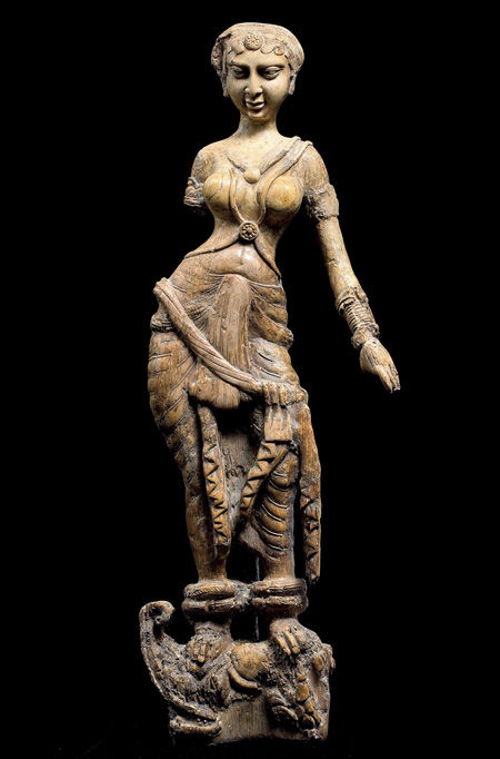 Female standing on a mythological creature