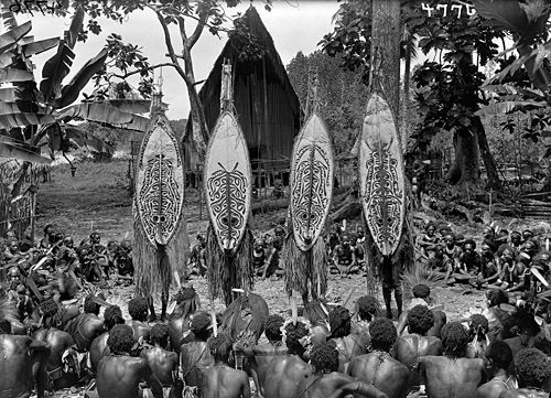 Four <i>Keveke</i> Dancers in front of the Longhouse (<i>Daima</i>) at Kinomere Village