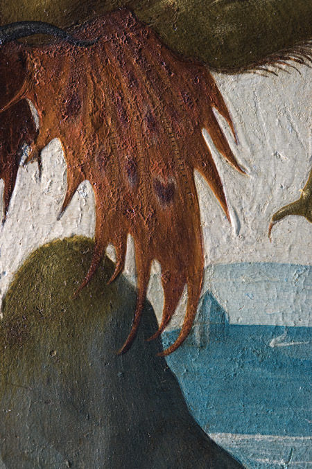 Demon's wing showing shriveling of paint surface