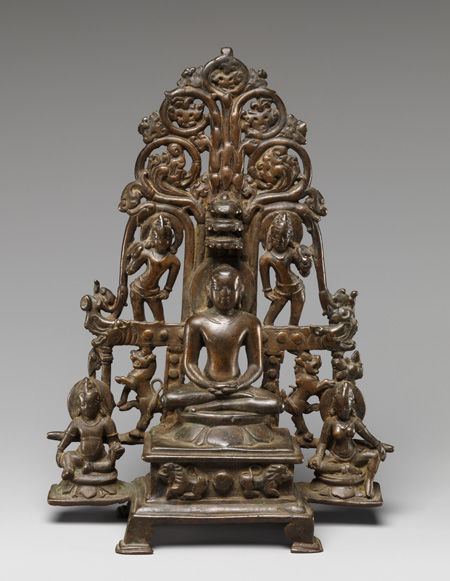 Enthroned Jina Attended by a <i>Yaksha</i>, a <i>Yakshi</i>, and <i>Chauri</i>-Bearers