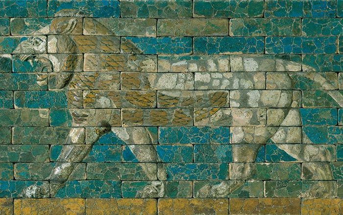 Panel with striding lion, facing left, made of blue, tan and ochre ceramic tiles