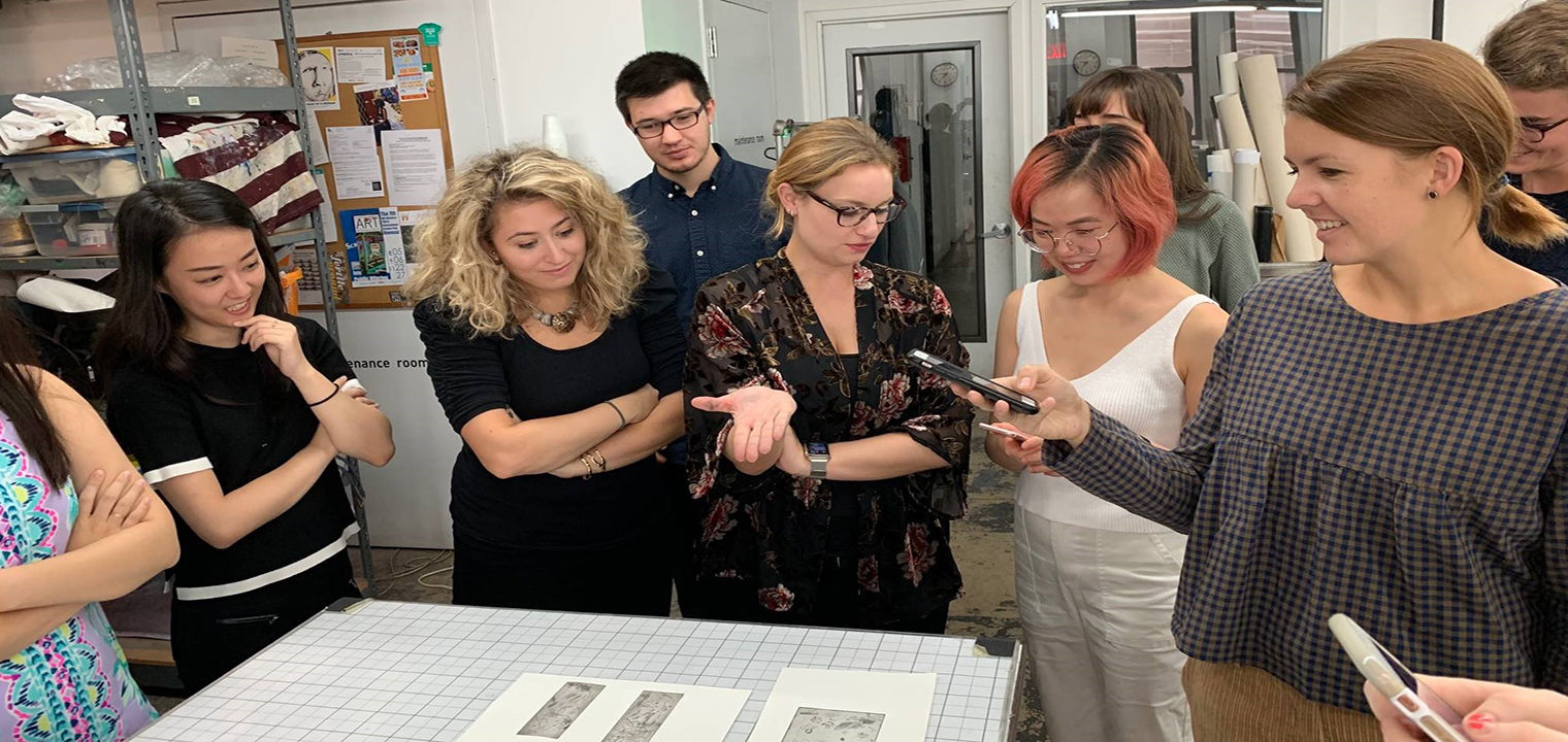 A group of 6 college students gathered in discussion around a table