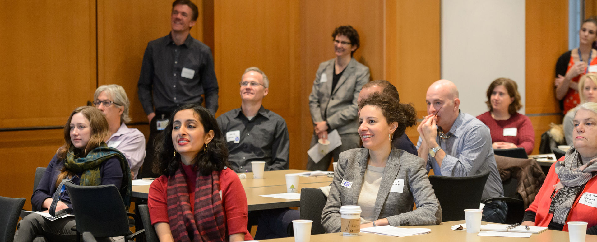 University students and faculty listening to a lecture