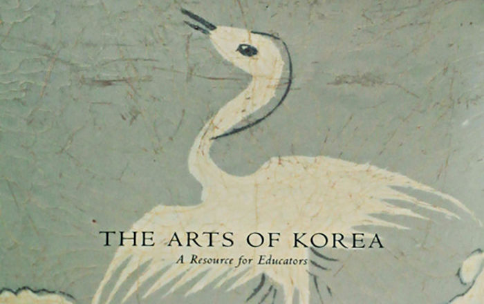 Cover of a brochure with a white crane in flight against a gray-green background