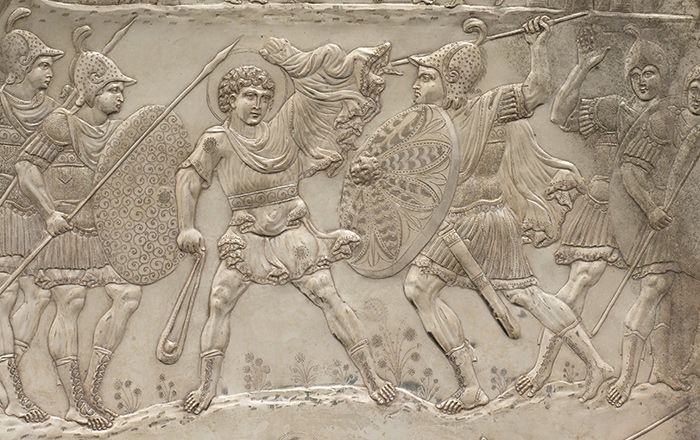 A large silver plate decorated in relief of two armies engaged in battle