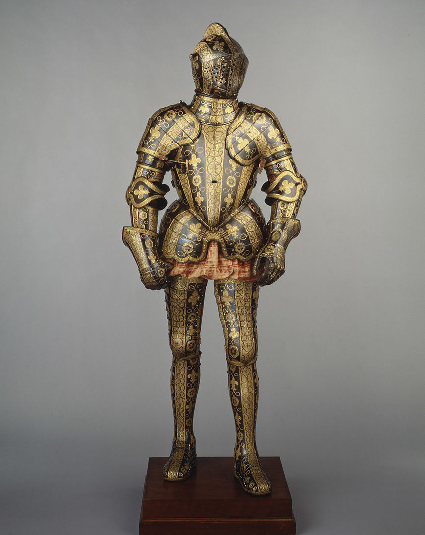 A suit of armor highly decorated with geometrical and floral patterns, blackened and gilded