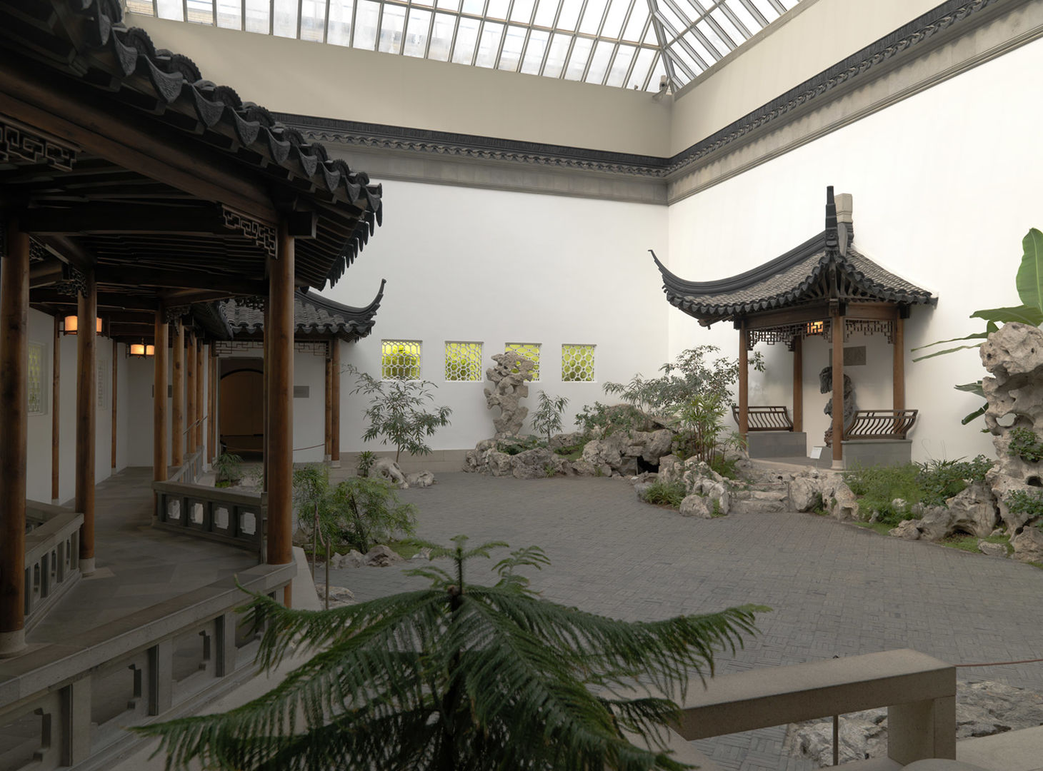 An interior courtyard with pagodas, plantings, ornamental rocks, and a fish pond