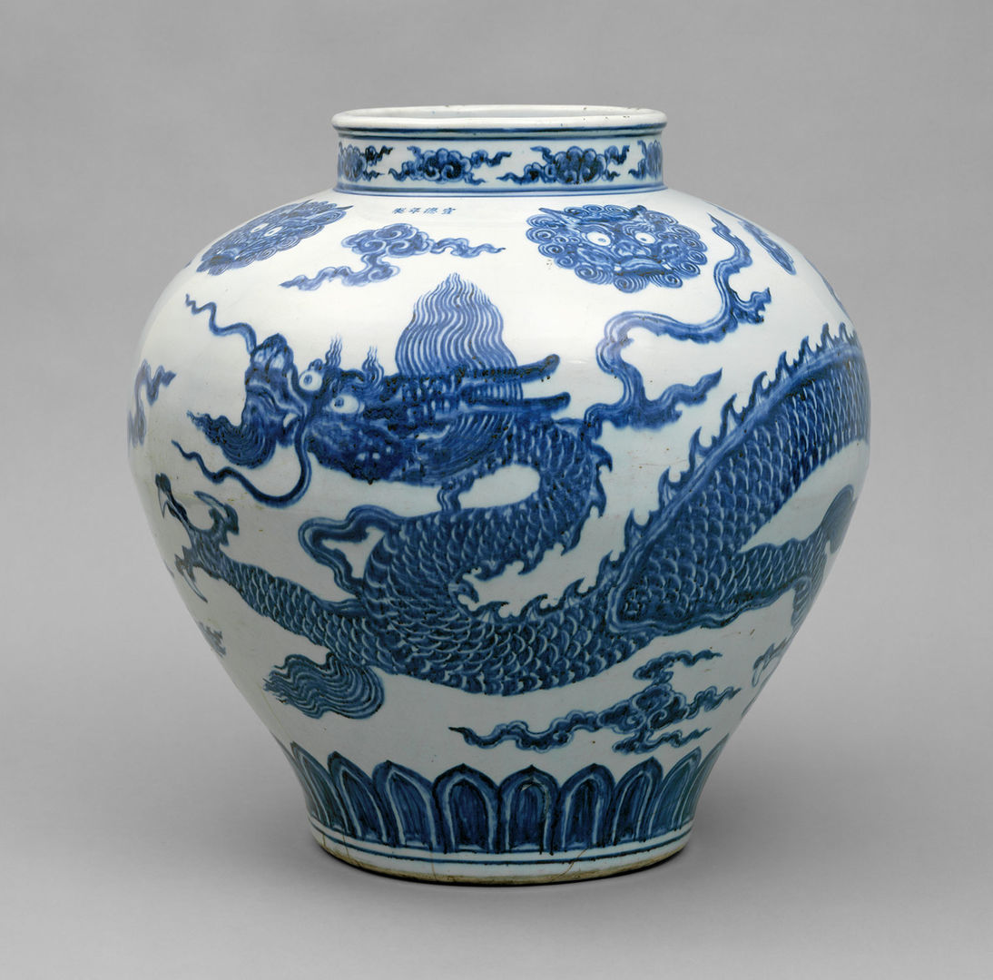 A white porcelain jar decorated with blue paint depicting a dragon.