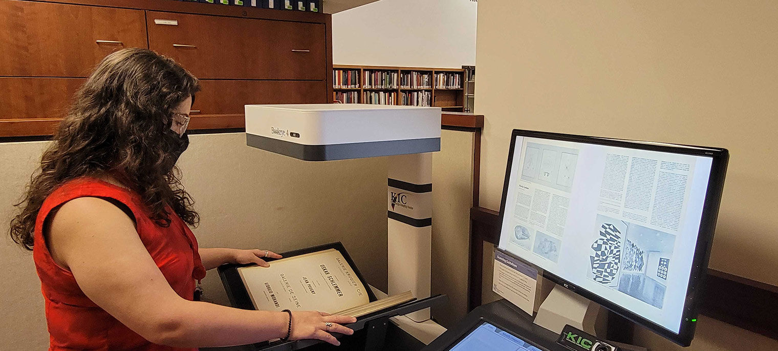 Librarian scanning a book