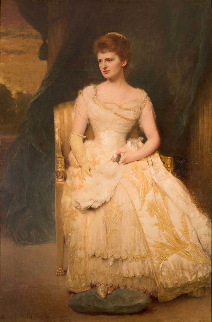 A well-dressed woman poses for a painting in an elegant off-white ballgown