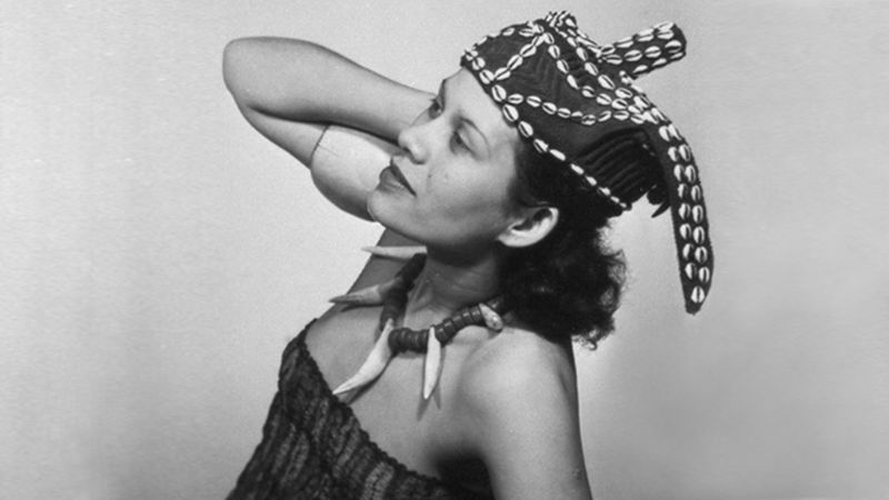 Adrienne Fidelin wearing a headdress decorated with cowrie shells
