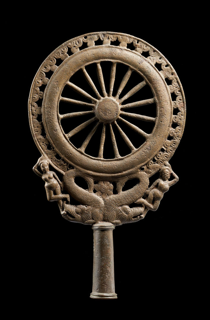 Decorative copper sculpture of a dharma wheel