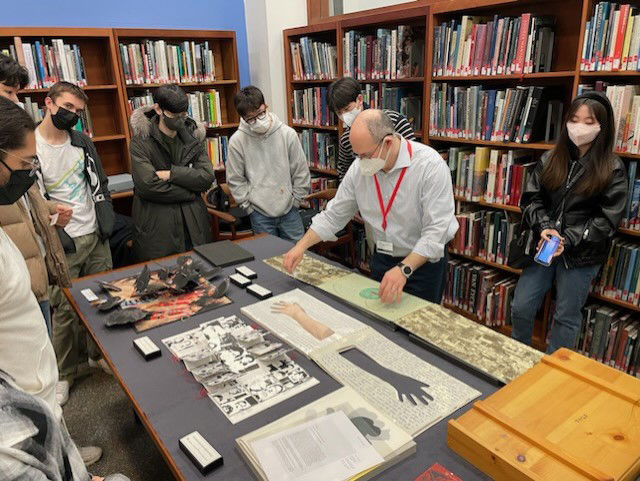 A visiting group looking at special collections material