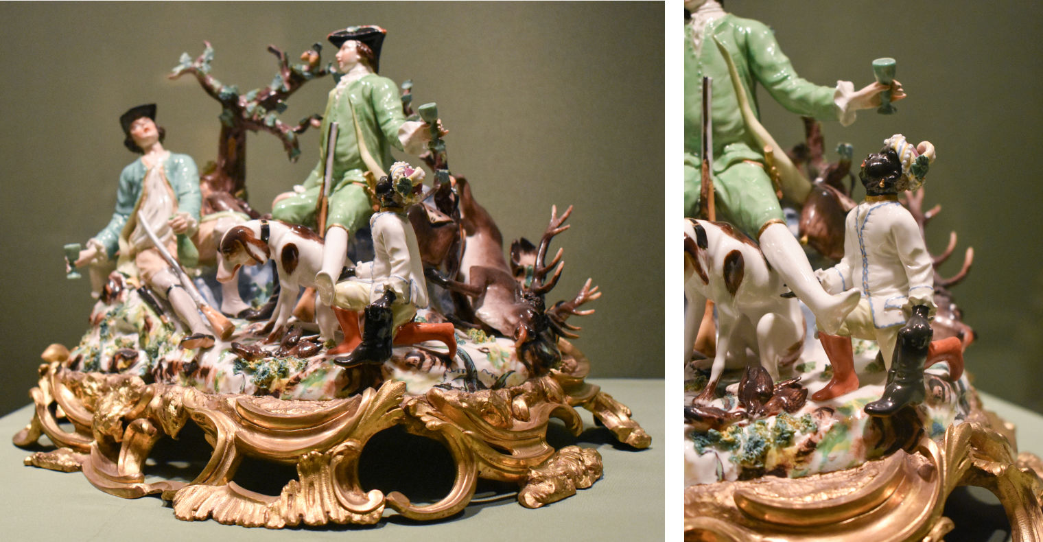 Porcelain figure showing two white hunters drinking, a dog, and a black person depicted at a smaller scale, kneeling next to them