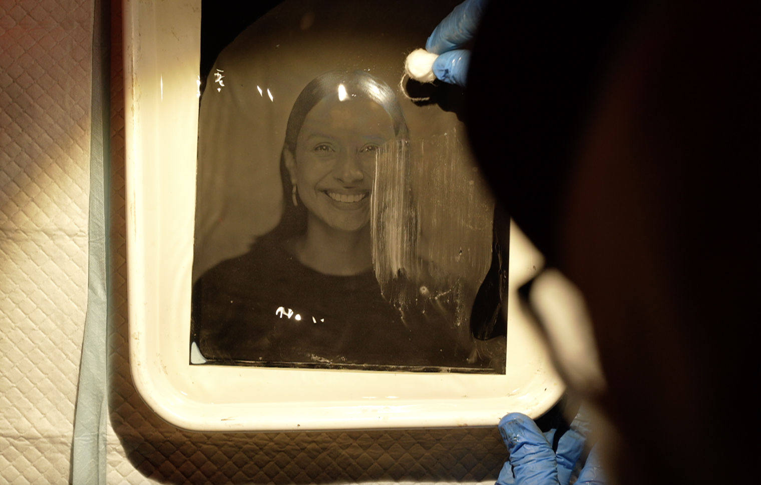 Process of developing a tintype portrait of a smiling woman